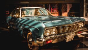 Classic vintage car displayed indoors showcasing elegant design and chrome detail.